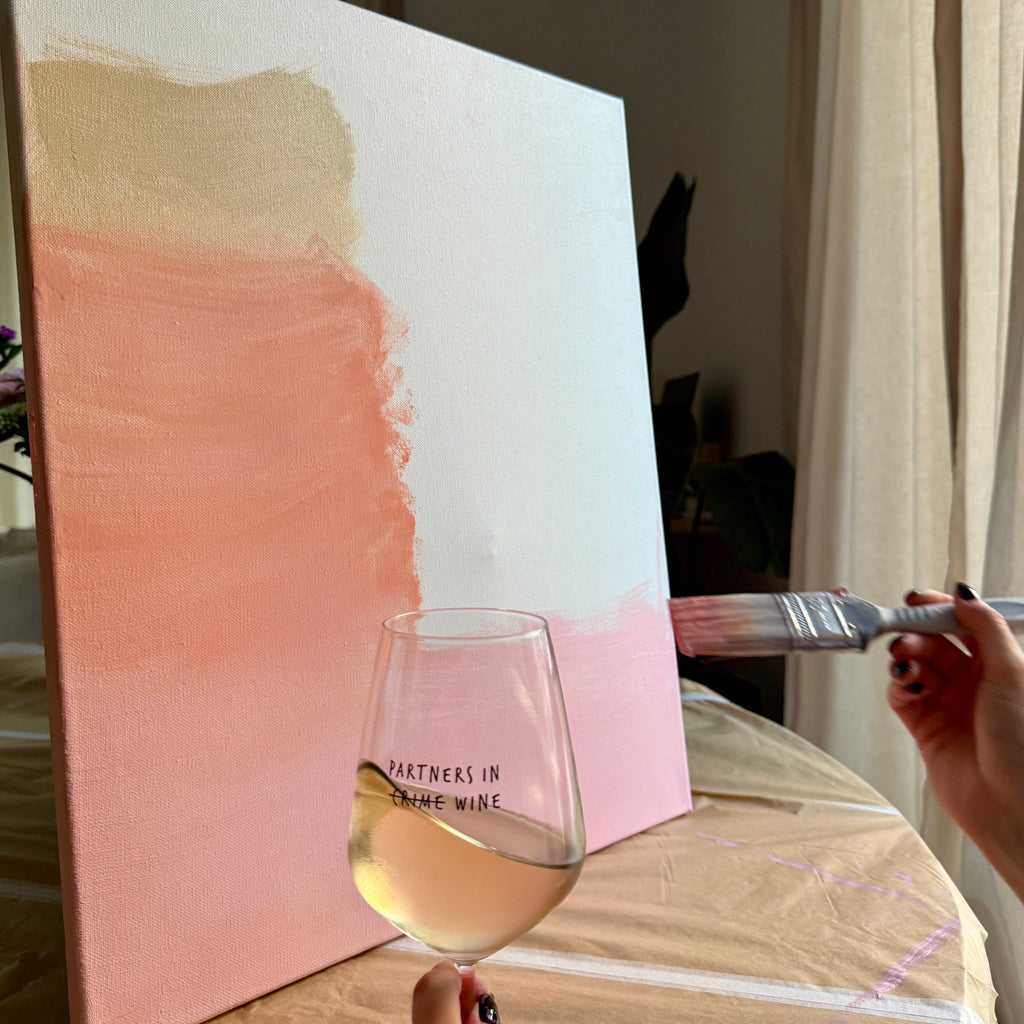Partners in Wine glass filled with white wine during arts and crafts. 